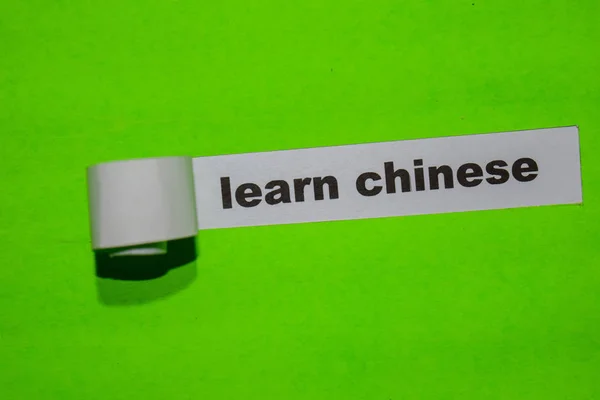 Learn Chinese, education concept on green torn paper