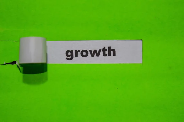 Growth, Inspiration and business concept on green torn paper