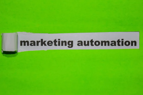 Marketing Automation, Inspiration and business concept on green torn paper