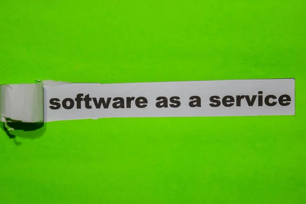 Software as a Service, Inspiration and business concept on green torn paper