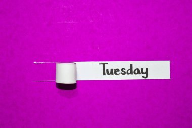 Tuesday text, Inspiration, Motivation and business concept on purple torn paper