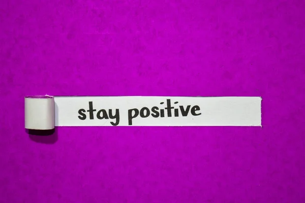 Stay positive text, Inspiration, Motivation and business concept on purple torn paper