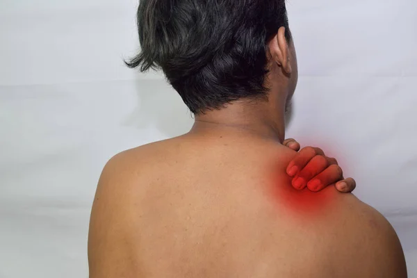 Man from back having red spot of pain and feeling exhausted and suffering from neck pain, health concept on white background