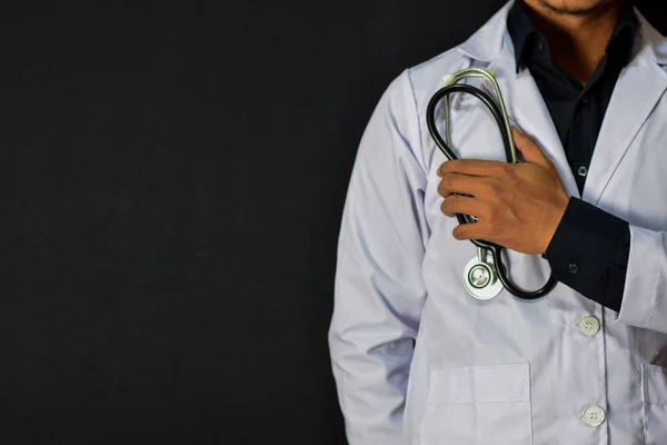 Physician or doctor holding stethoscope. Listening story patient concept. Isolated on black background