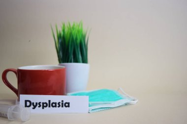 Dysplasia text, grass pot, coffee cup, syringe, and face green mask. Healtcare/Medical and Business concept clipart