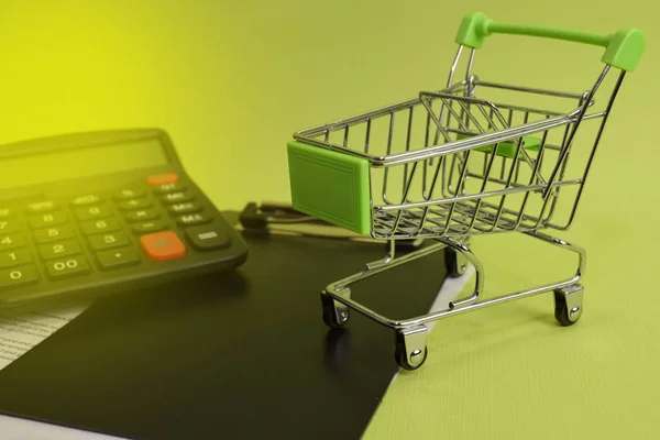 Calculator budget cost and analysis financial. Selective focus on shopping cart. Business and finance concept of office desk