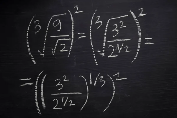 Close up math formulas written on a blackboard. Education concept