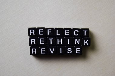 Reflect - Rethink - Revise on wooden blocks. Business and inspiration concept clipart