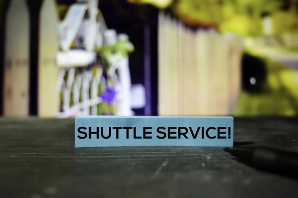Shuttle Service! on the sticky notes with bokeh background
