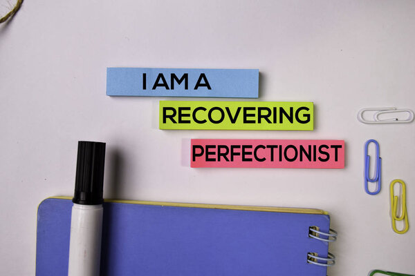 I am A Recovering Perfectionist on sticky notes isolated on white background.
