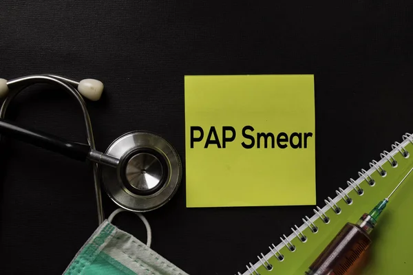 PAP Smear text on top view black table with blood sample and Healthcare/medical concept.