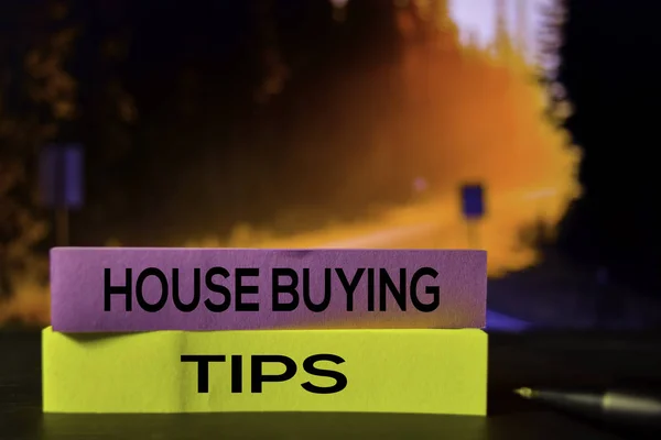 House Buying Tips on the sticky notes with bokeh background