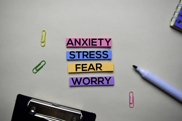 Anxiety - Stress - Fear - Worry text on sticky notes with office desk concept