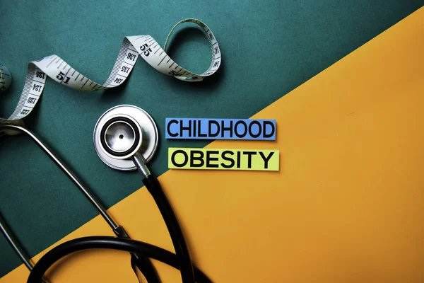 Childhood Obesity text on top view color table and Healthcare/medical concept.