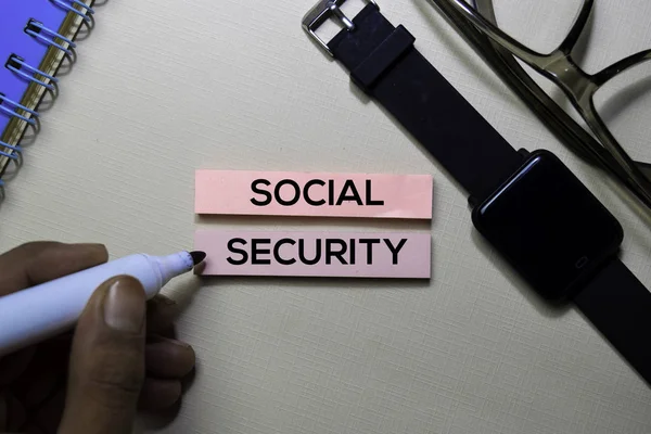 Social Security text on sticky notes isolated on office desk