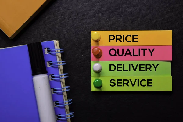 Price, Quality, Delivery, Service text on sticky notes isolated on Black desk. Mechanism Strategy Concept