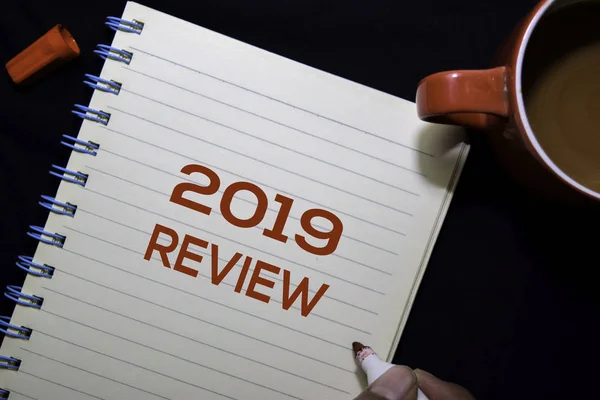 2019 Review text on the book isolated on office desk background — Stock Photo, Image