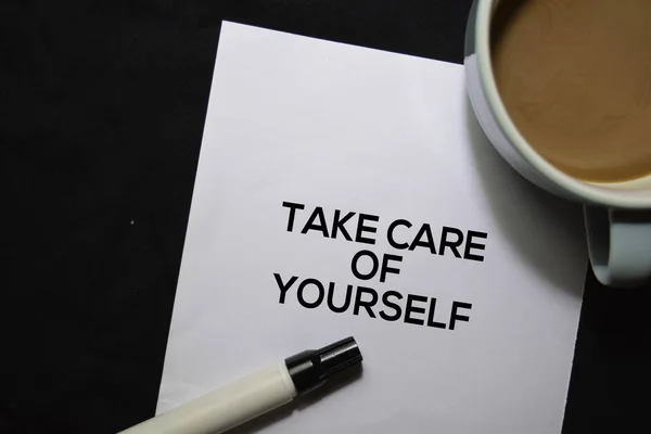 Take Care Of Yourself text on the paper isolated on office desk background