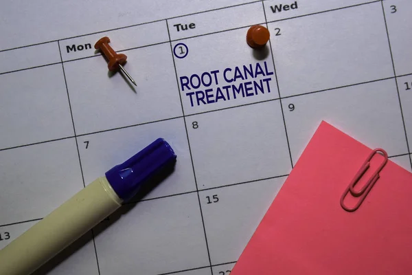 Root Canal Treatment text on white calendar background. Reminder or schedule concept