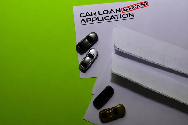 Car Loan Application in Approved with post card on office desk background