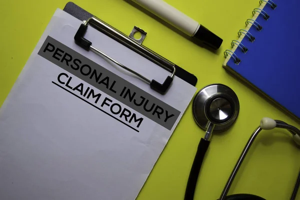 Personal Injury Claim Form on the Document with yellow background. Healthcare or Medical concept — Stock Photo, Image