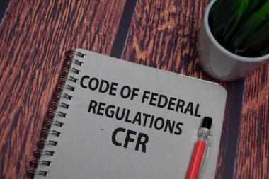 Book about Code Of Federal Regulations - CFR isolated on wooden table. clipart