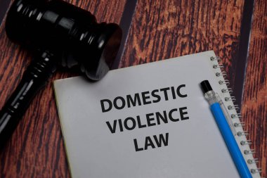 Book about Domestic Violence Law isolated on wooden table.