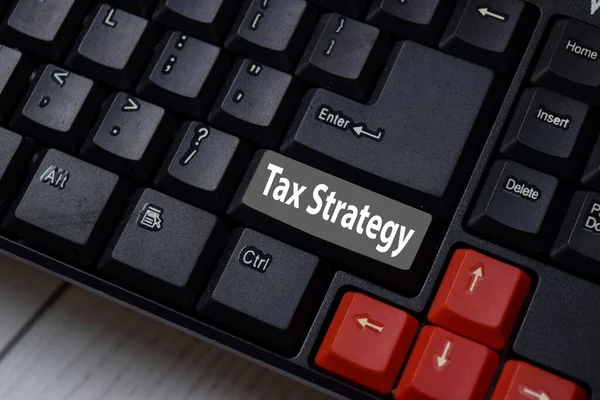 Tax Strategy write on keyboard isolated on laptop background