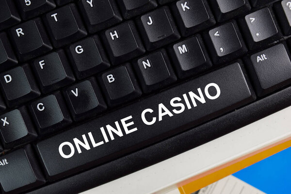 Online Casino write on keyboard isolated on laptop background