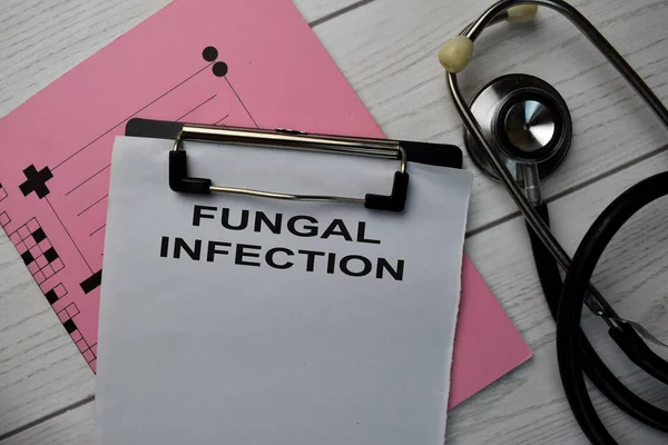 Fungal Infection text write on a paperwork and stethoscope isolated on office desk.