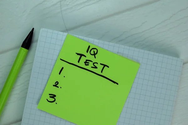 IQ Test write on sticky notes Supported by an additional services isolated on office desk.