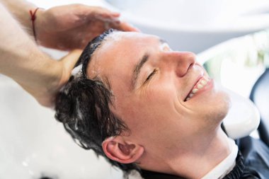 Genç bir beyaz adam onun saç güzellik salonunda yıkanmış olması Close-Up.