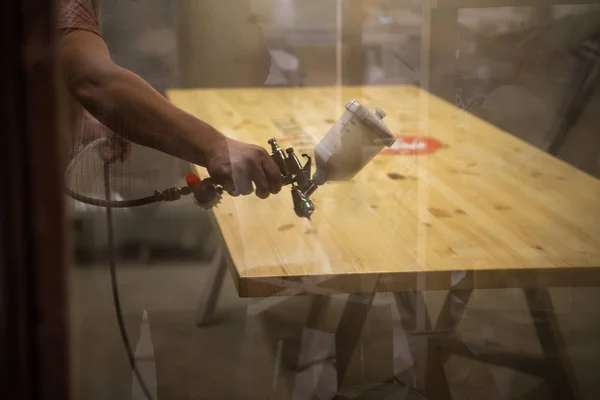 Master painter in a factory - industrial painting wood with spray gun. Soft focus — Stock Photo, Image