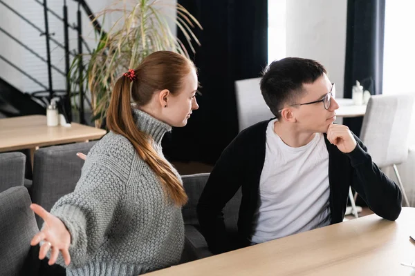 Kızgın çift kanepe kafede oturan savunarak. Adam kız arkadaşı yok sayar.