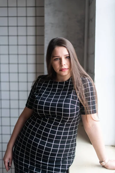 Artı günlük kıyafetlerle manken boy, stüdyo arka planında kadın, kilolu kadın vücudu.