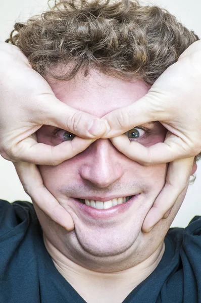 Portrait of young surprised emotional big eyes man with open mouth