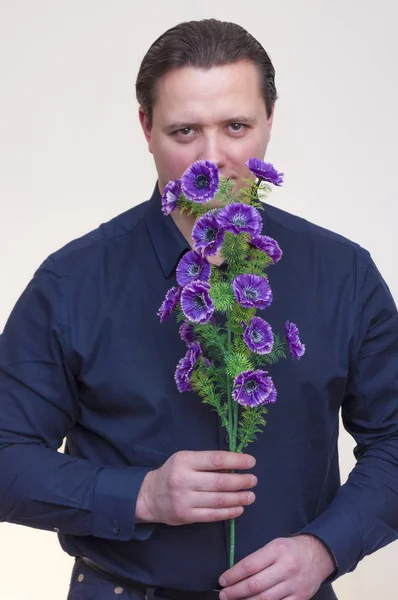 Portrait Young Athletic Elegant Man Holding Artificial Violet Centaurea Flowers — Stock Photo, Image