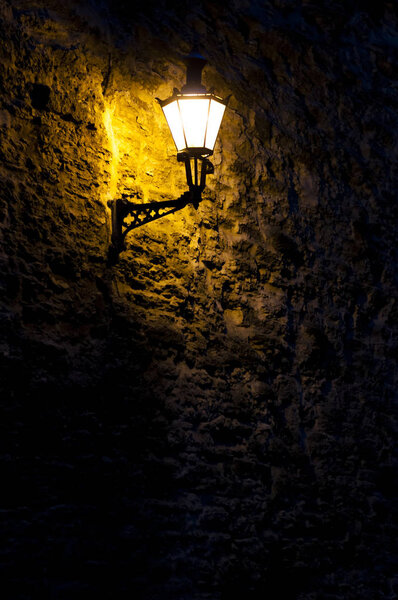 Wall lantern at night on the fortress wall in Tallinn