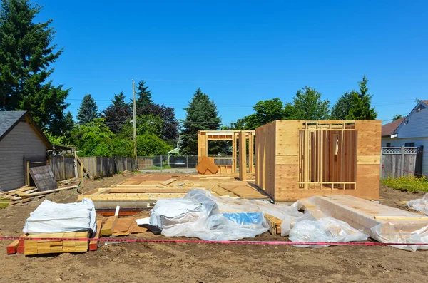 Single family home under construction on blue sky background