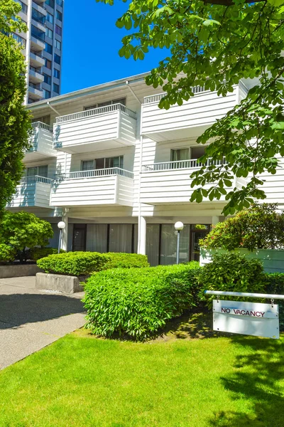 Low-rise apartment building on a sunny day with blue sky background