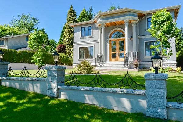 Luxury family house with concrete driveway and garage on back yard