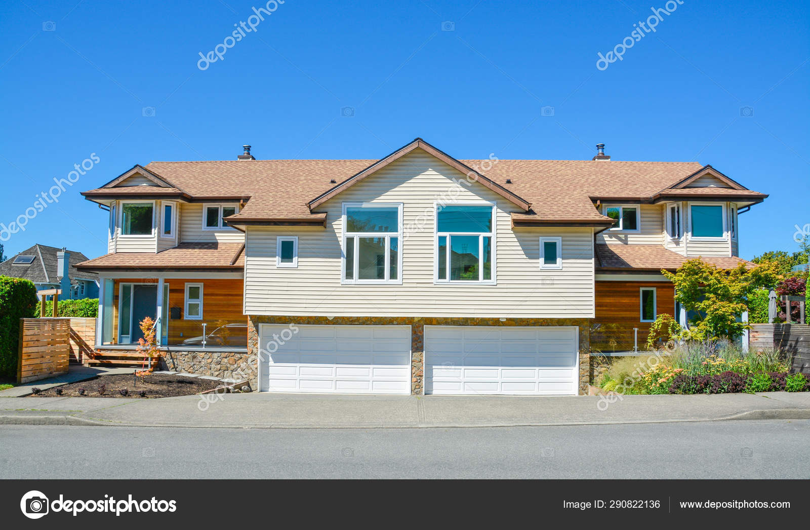 Duplex House For Two Families With Wide Garage Doors Along The