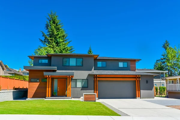 Residential house with wide garage door and concrete driveway