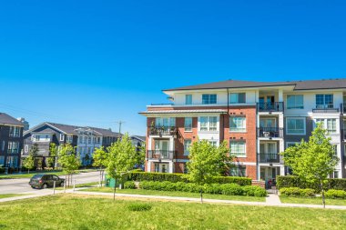 Brand new low rise apartment building on sunny day in British Columbia, Canada. clipart