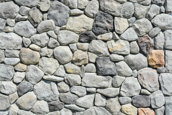 Piedras surtidas en fondo de textura de pared. Material de construcción moderno . — Foto de Stock