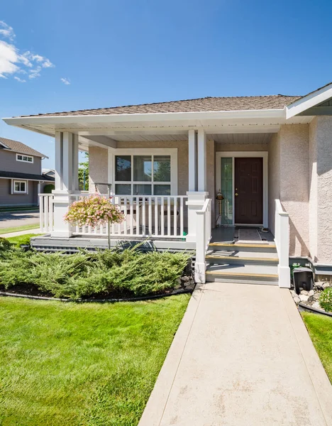 Entrance of residential house with concrete pathway in front of the house