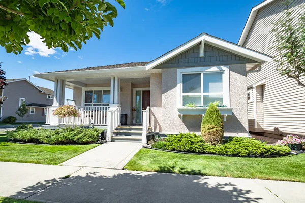 Entrance of residential house with concrete pathway in front of the house