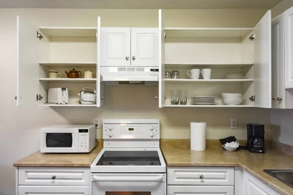 Otwarte szafki i urządzenia gospodarstwa domowego średnio kuchnia domowa. — Zdjęcie stockowe
