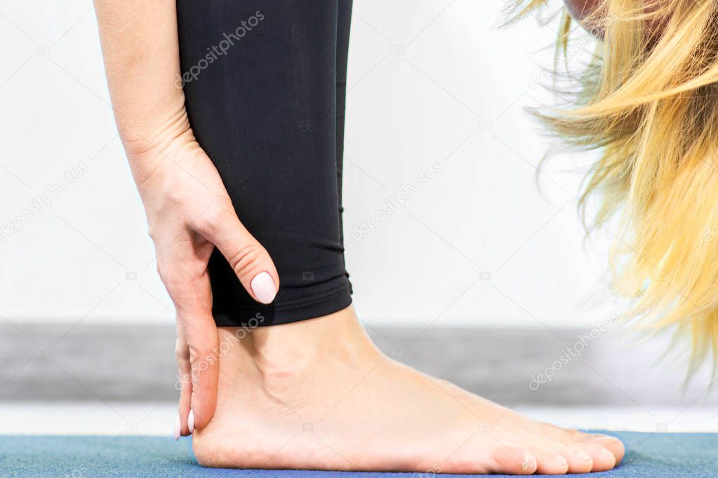 Closeup Attractive young yoga woman doing stretching standing on