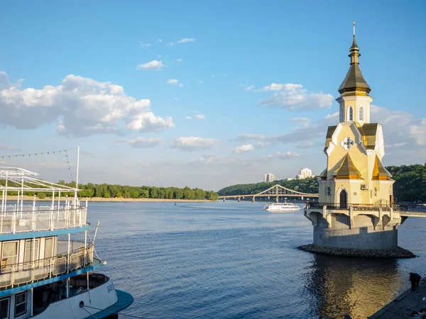 Beautiful landscape of the summer city of Kiev. View of the river and small church on the water.